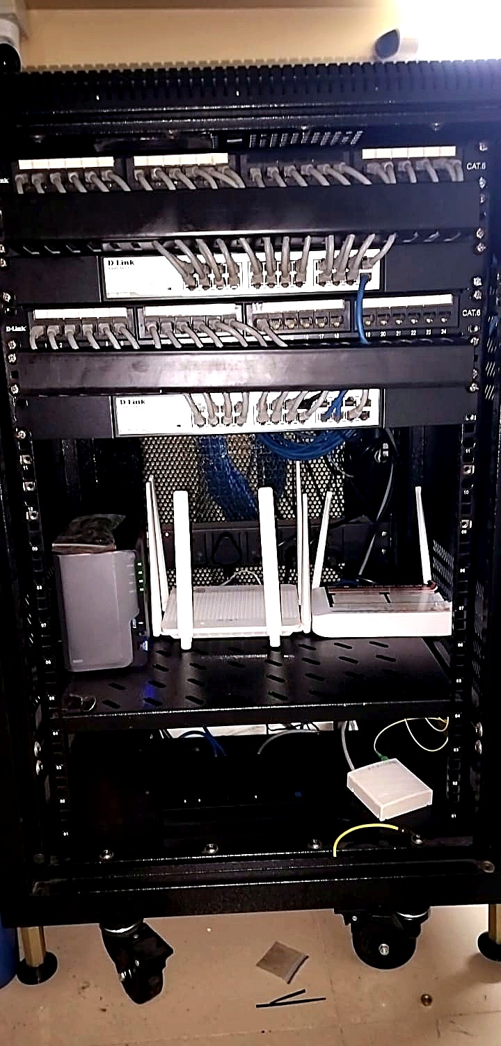 After: short patch leads dressed port to port across D-Link Cat6 panels, with the panel labelling left visible.