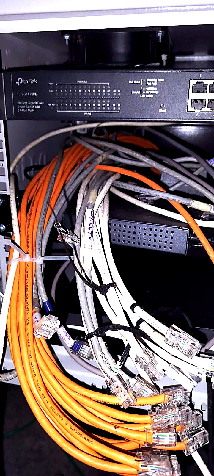 Before: a hanging bundle of orange and grey Cat6 tails with bare RJ45 plugs below a TP-Link PoE switch.